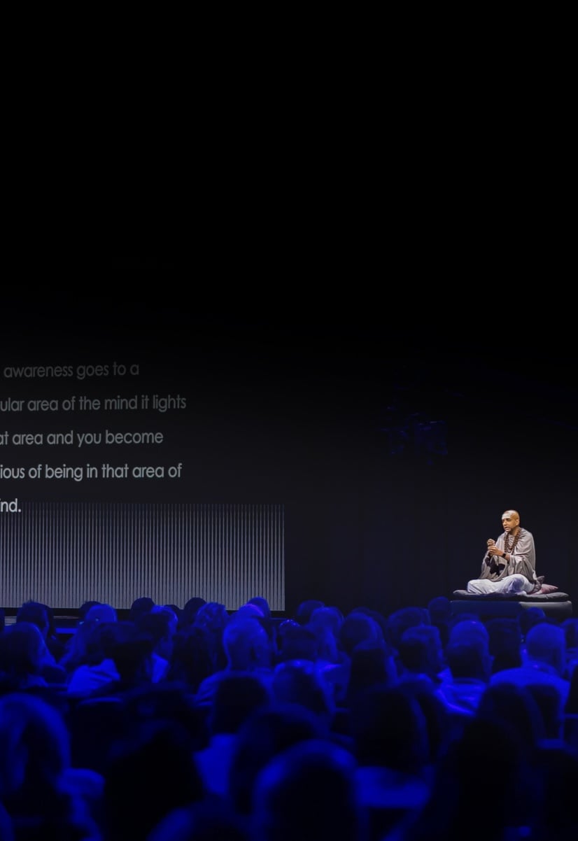 Dandapani speaking in front of a crowd